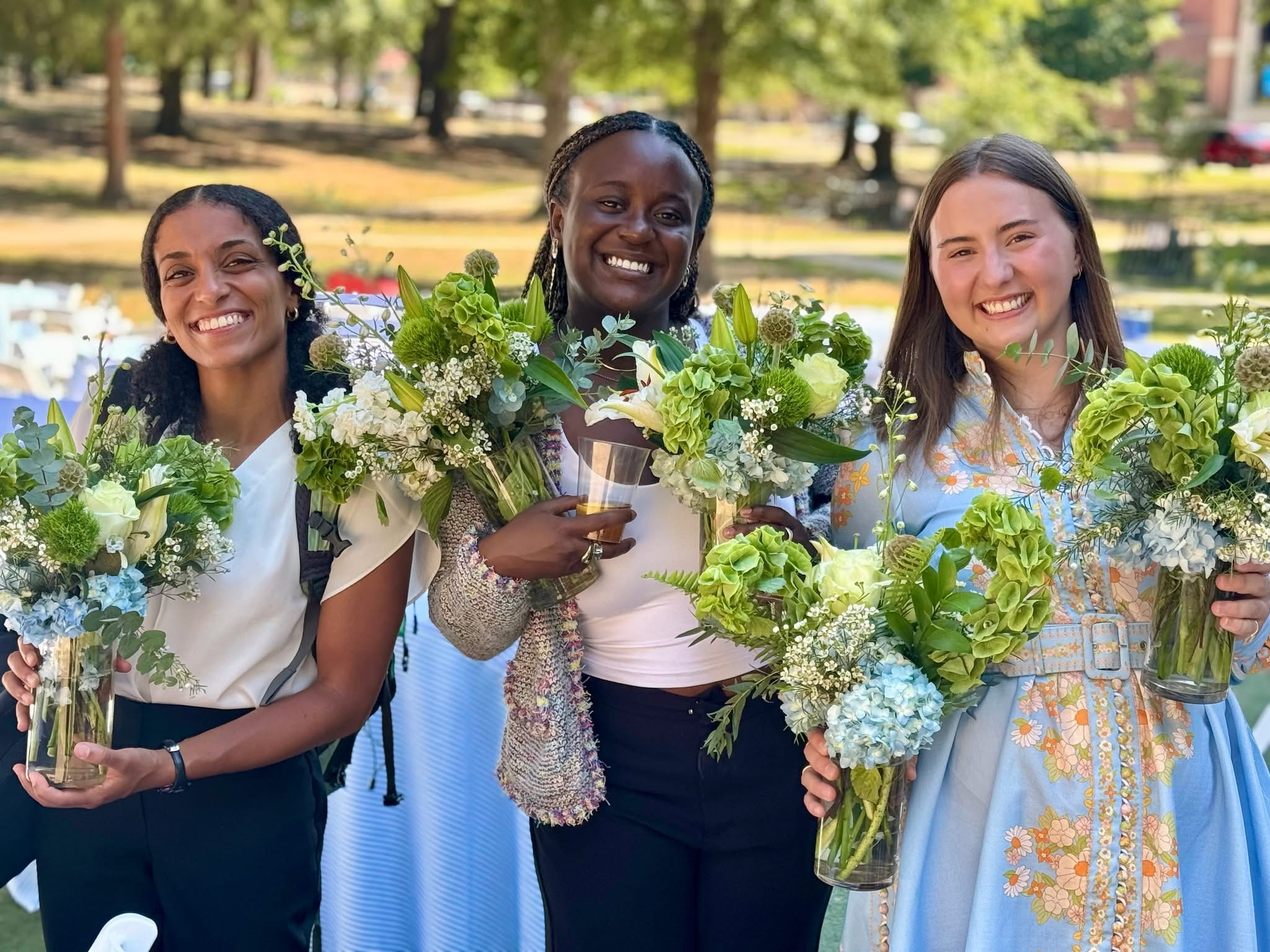 Liz Basha AC Buckley and Eron Hendrix stand with flowers by Ethel Scurlock